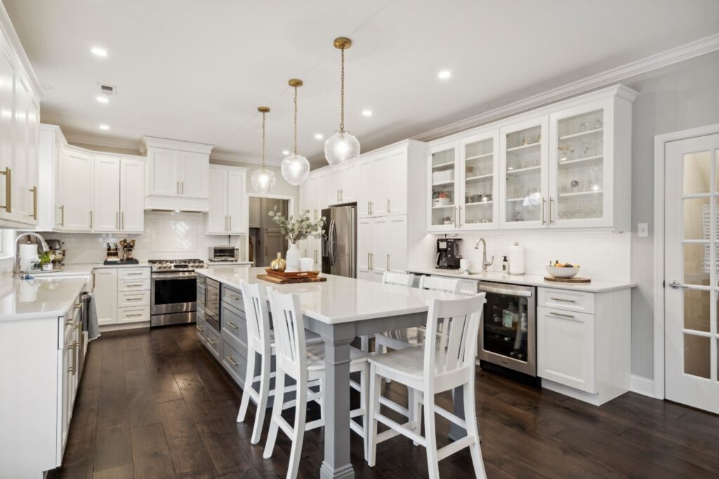 A remodeled kitchen in white with bright lighting.